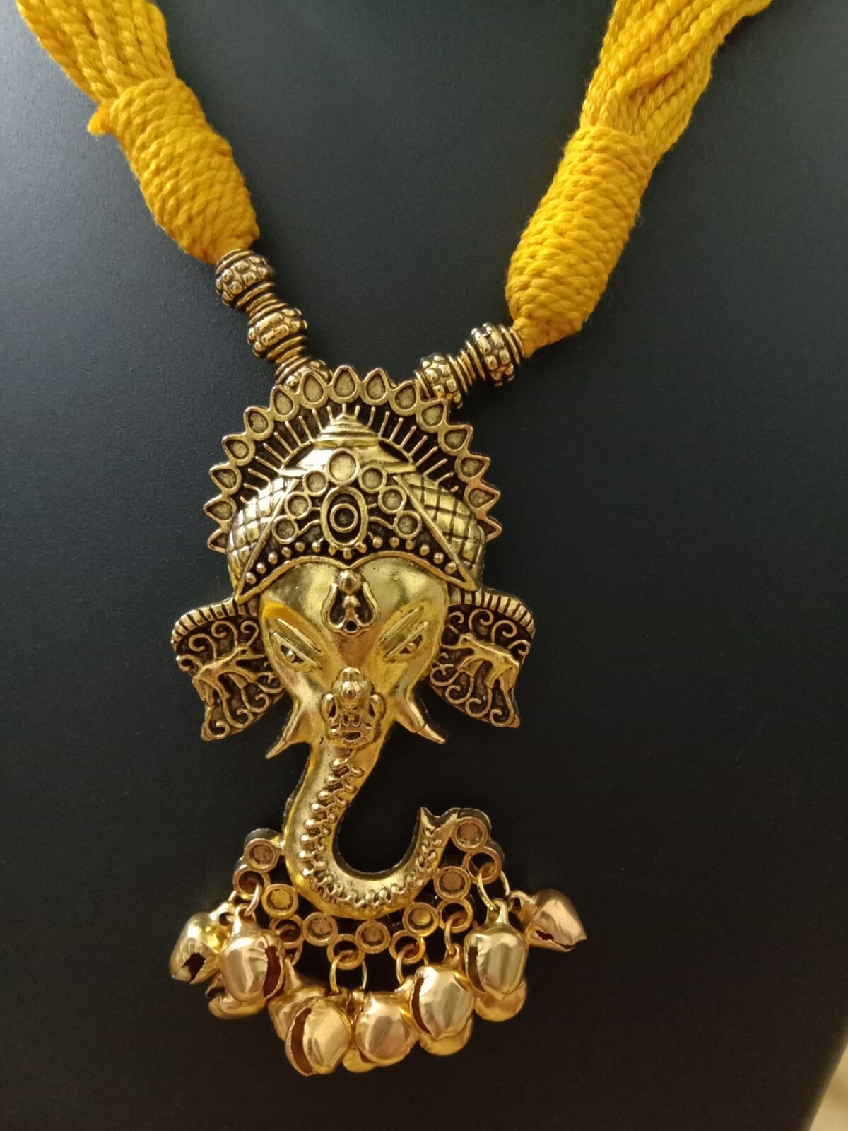 Oxidised golden ganesha traditional pendant and matching earrings.