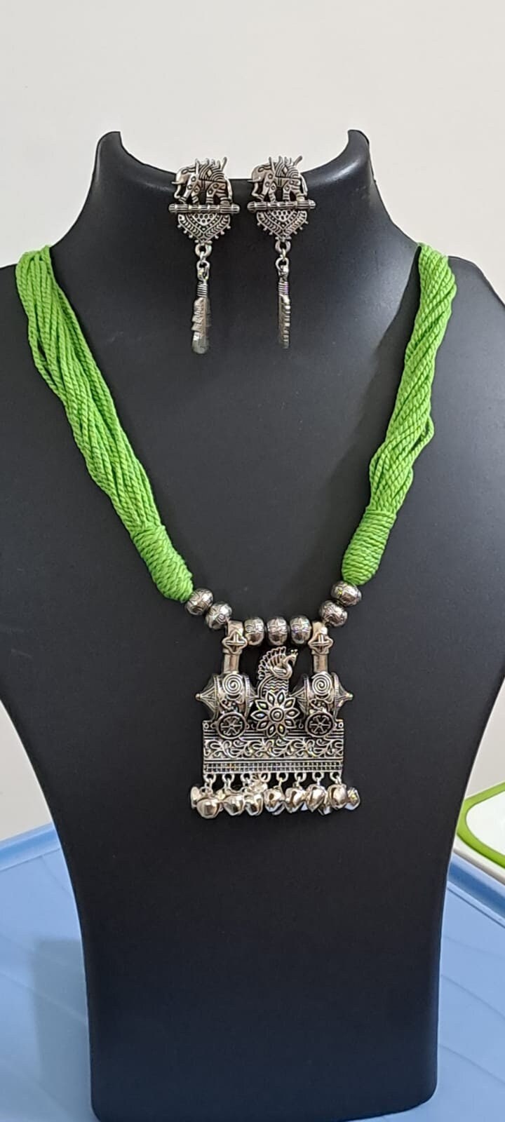 Light green thread necklace with silver oxidised traditional pendant