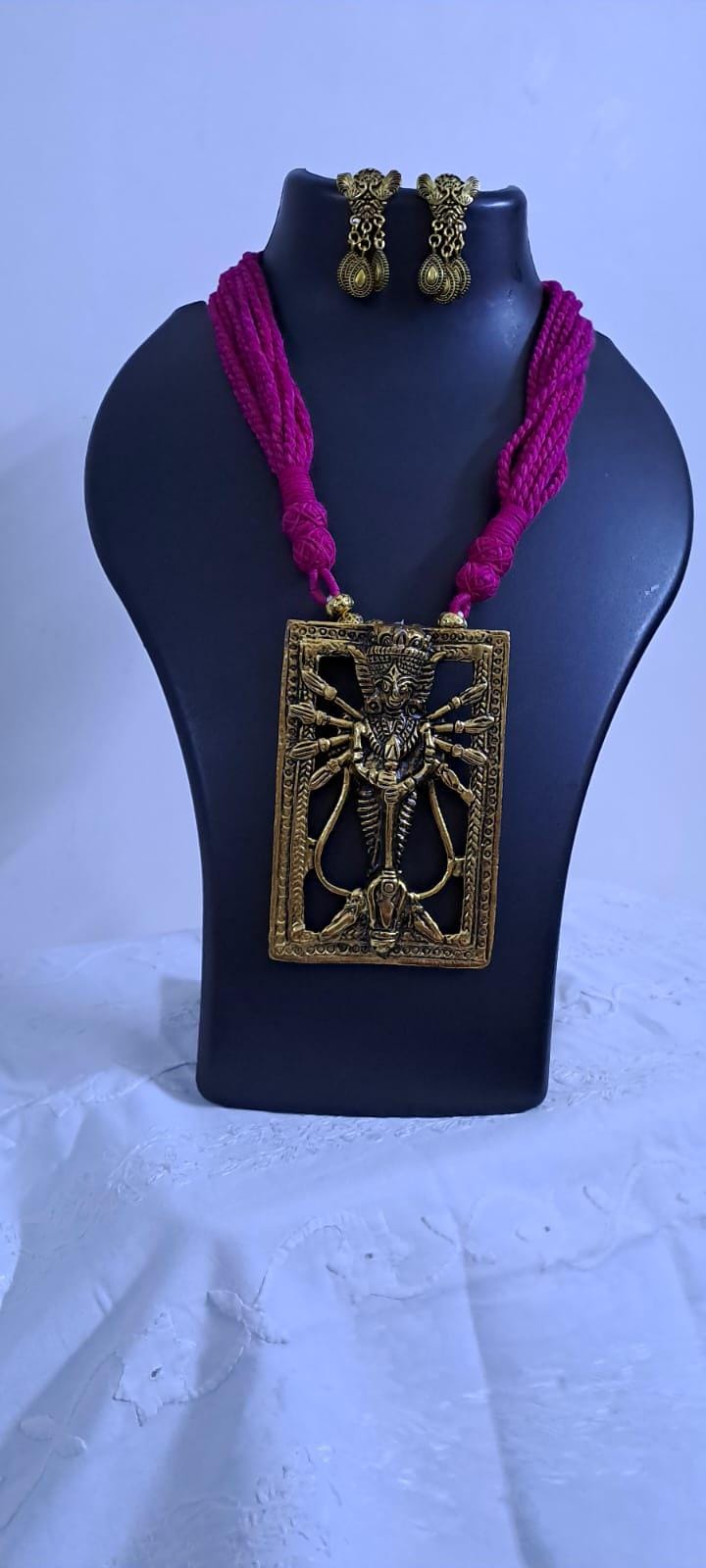 Pink thread necklace with oxidised golden durga pendant