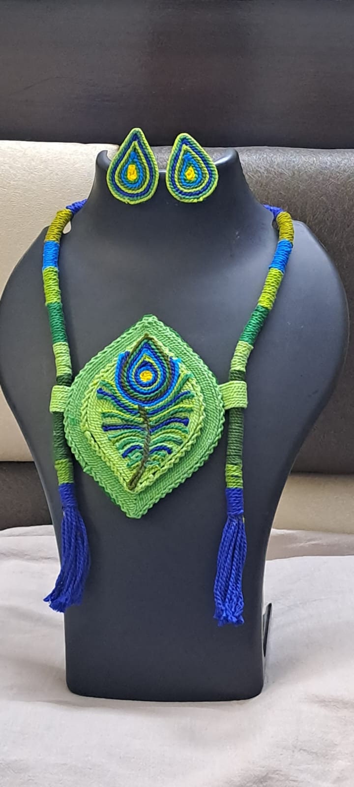 Thread necklace depicting peacock feather with shades of green. Exclusively for Janmashtami