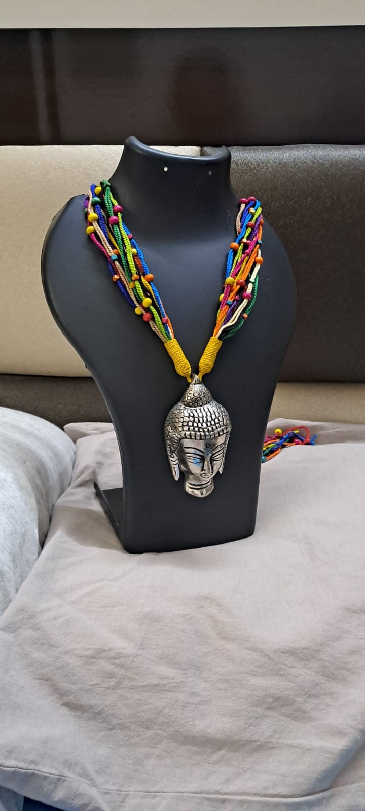 Multi coloured thread necklace with oxidised silver buddha pendant