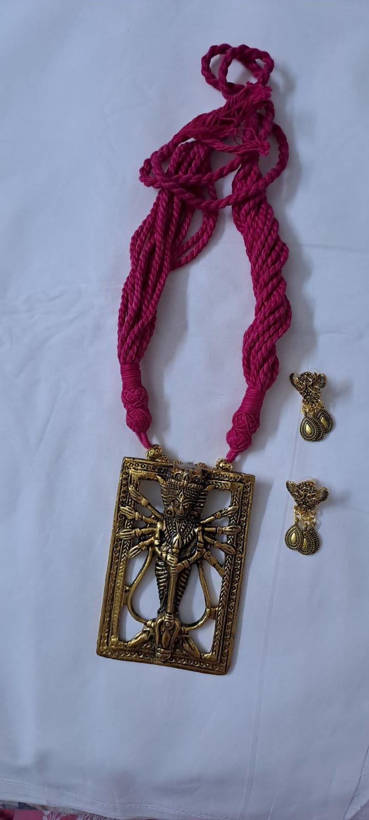 Pink thread necklace with oxidised golden durga pendant