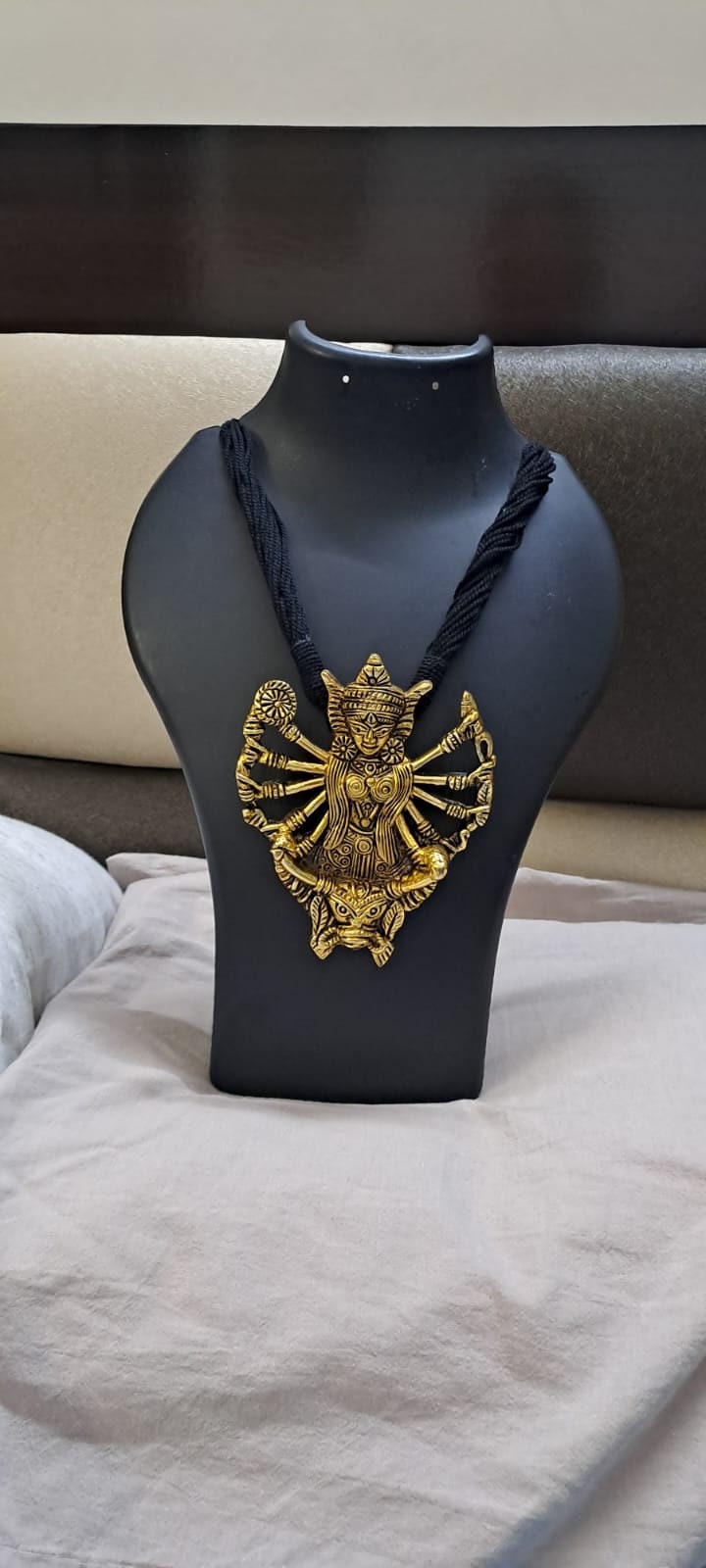 Black thread necklace with oxidised golden durga pendant