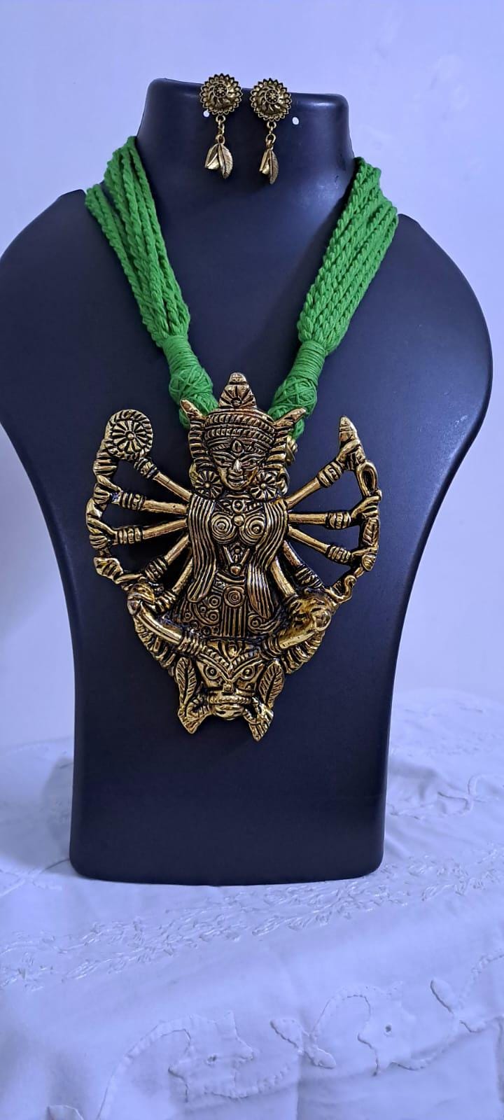 Green thread necklace with oxidised golden durga pendant