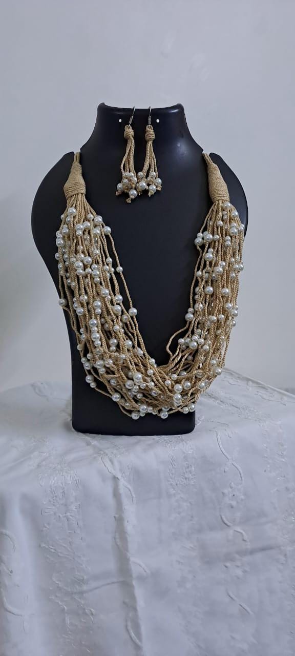 Multi layered jute necklace with pearl beads and with matching earrings.
