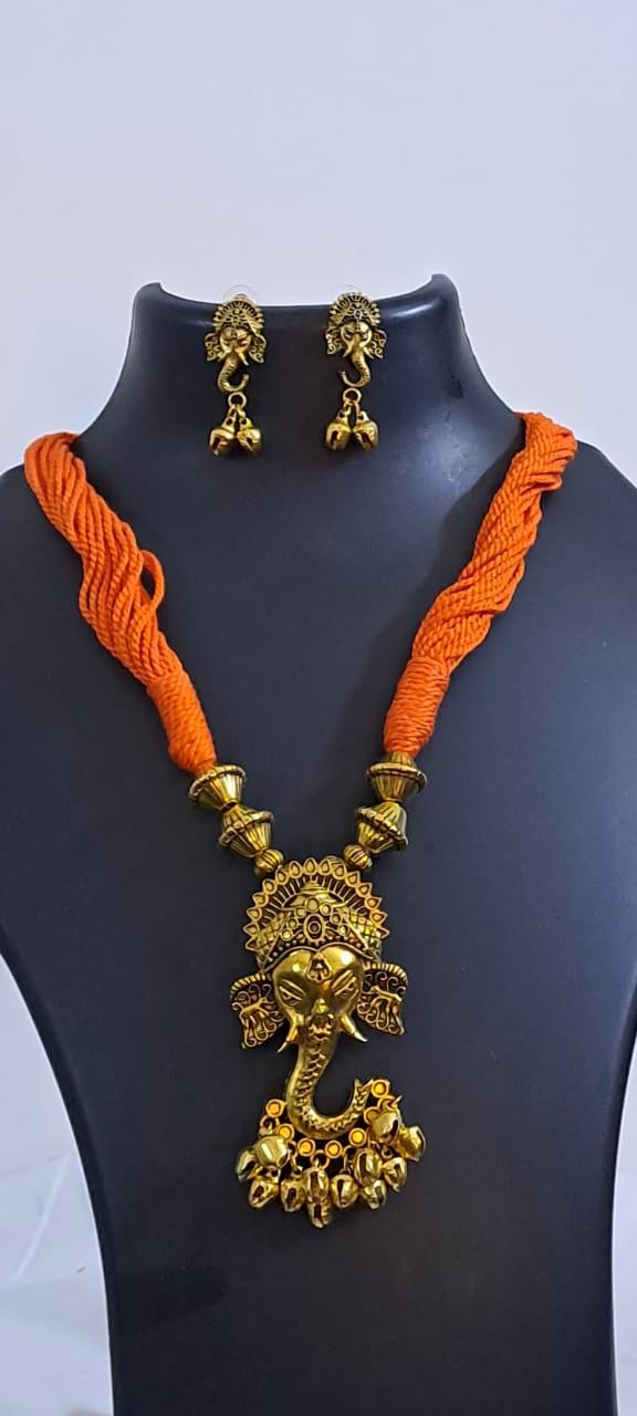 Orange thread necklace with Golden oxidised traditional pendant