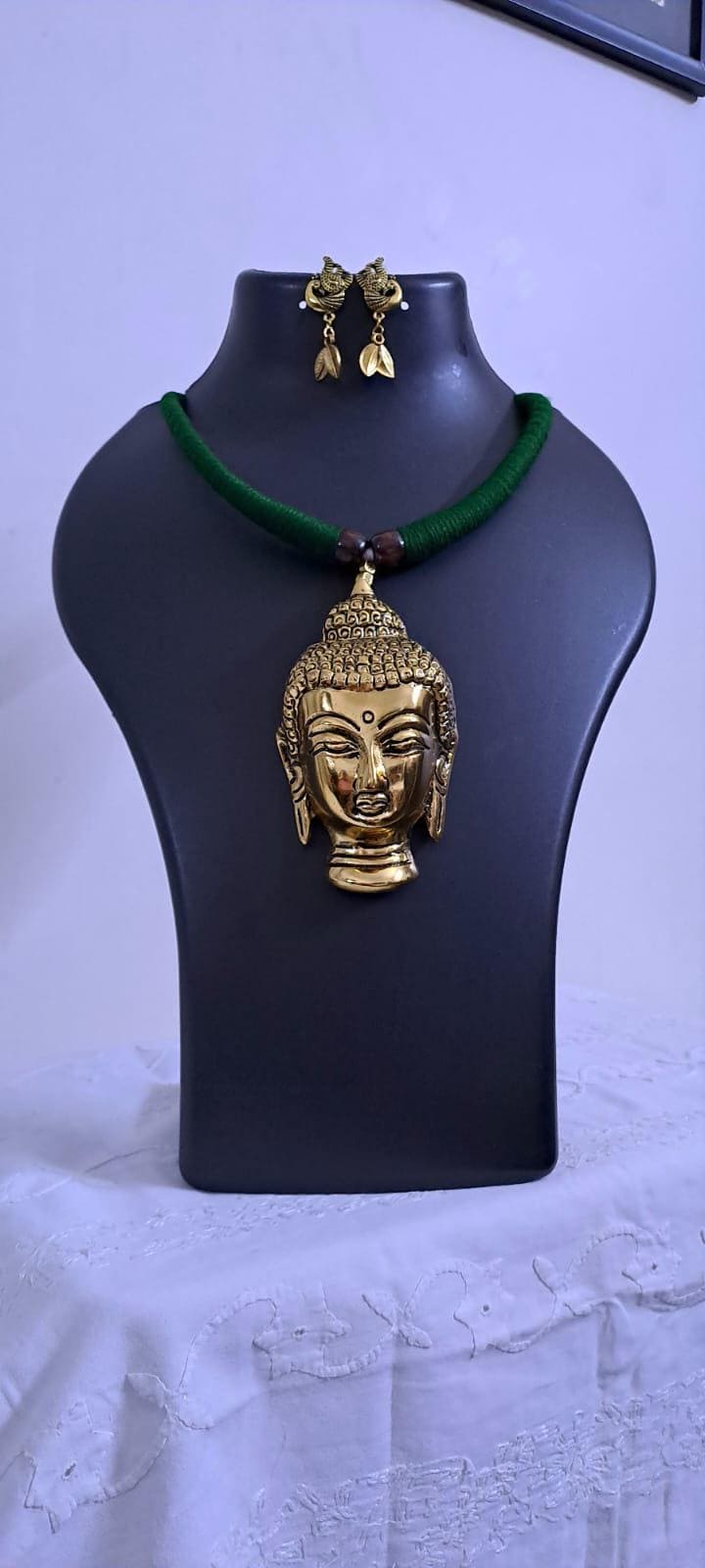 Green thread necklace with oxidised golden buddha pendant