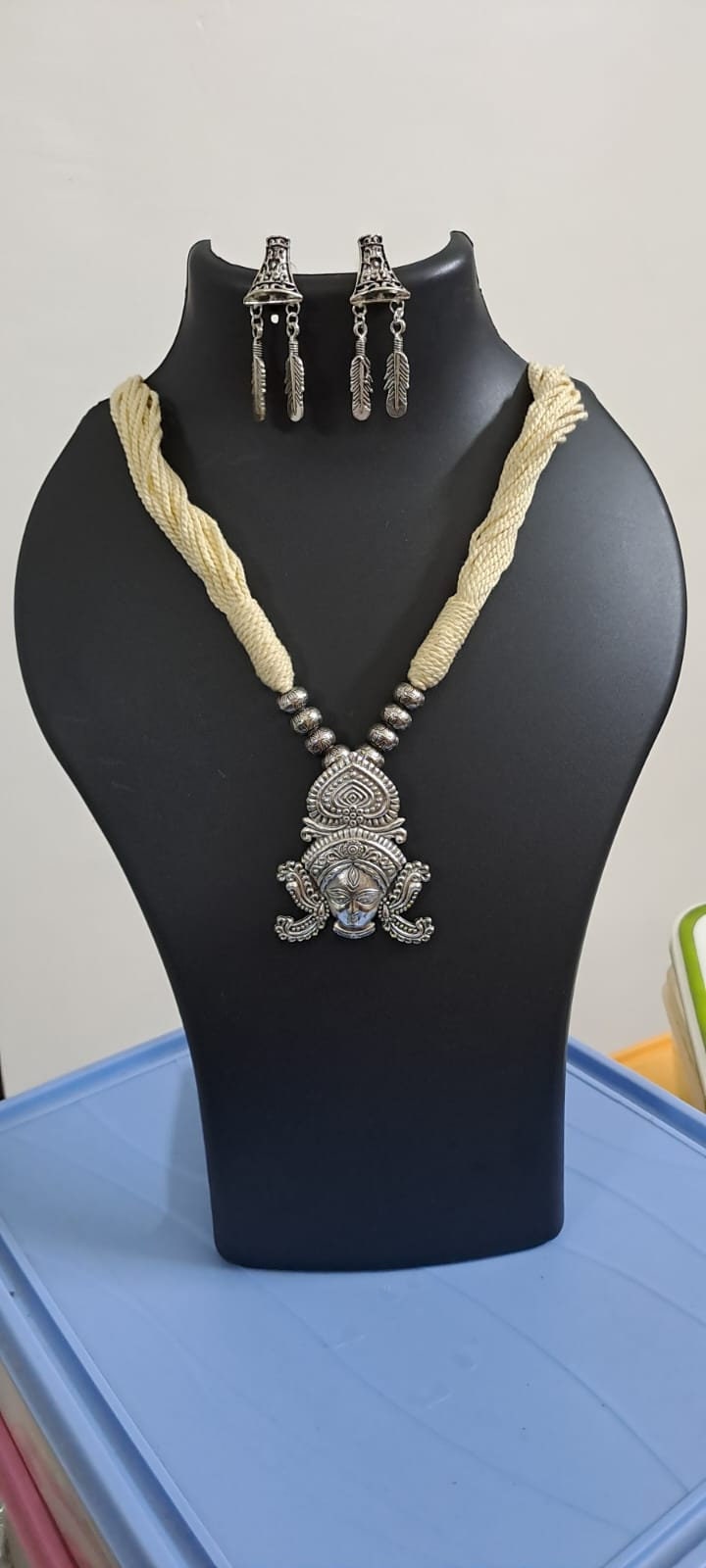 Off white thread necklace with oxidised silver durga pendant