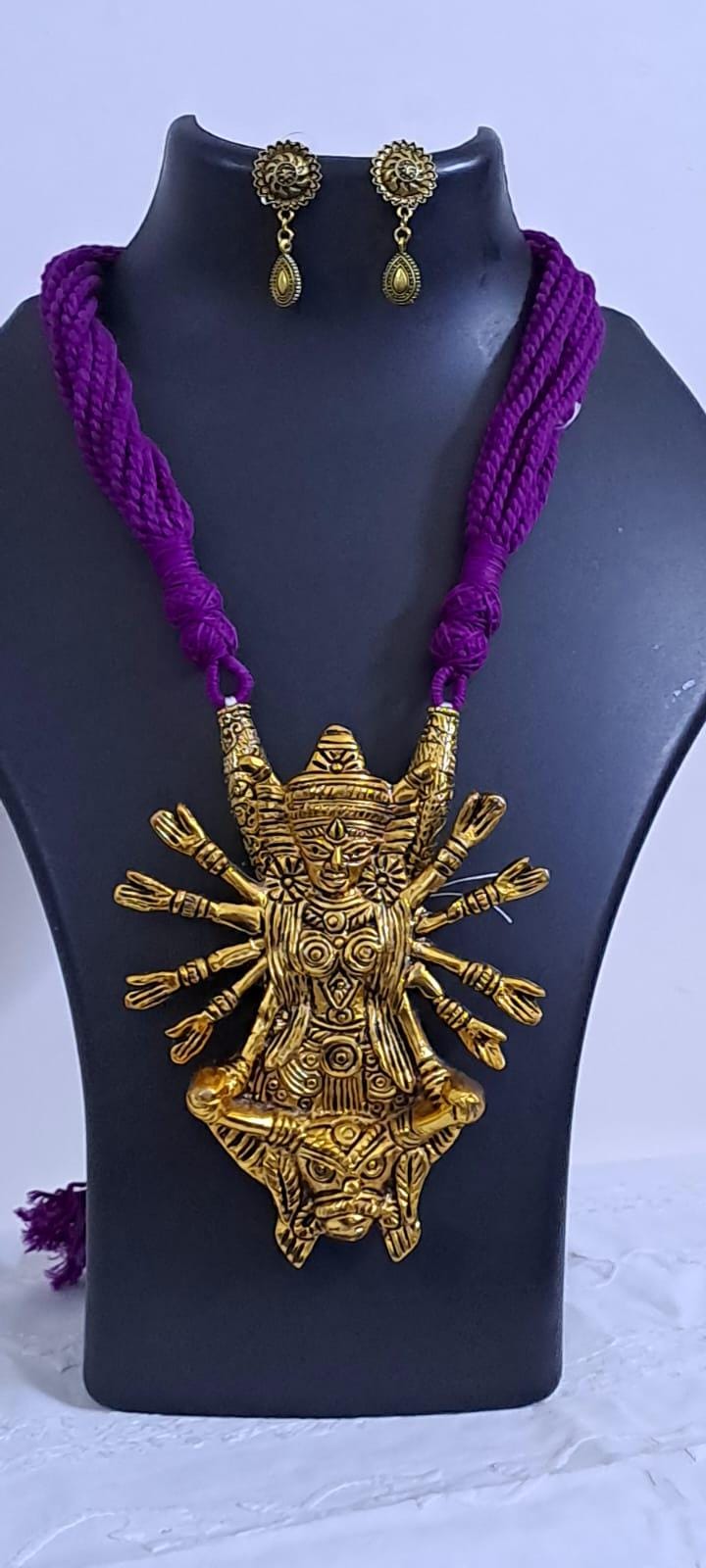 Purple thread necklace with oxidised golden durga pendant