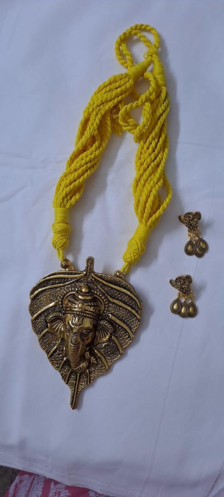 Yellow thread necklace with golden oxidised ganesha pendant