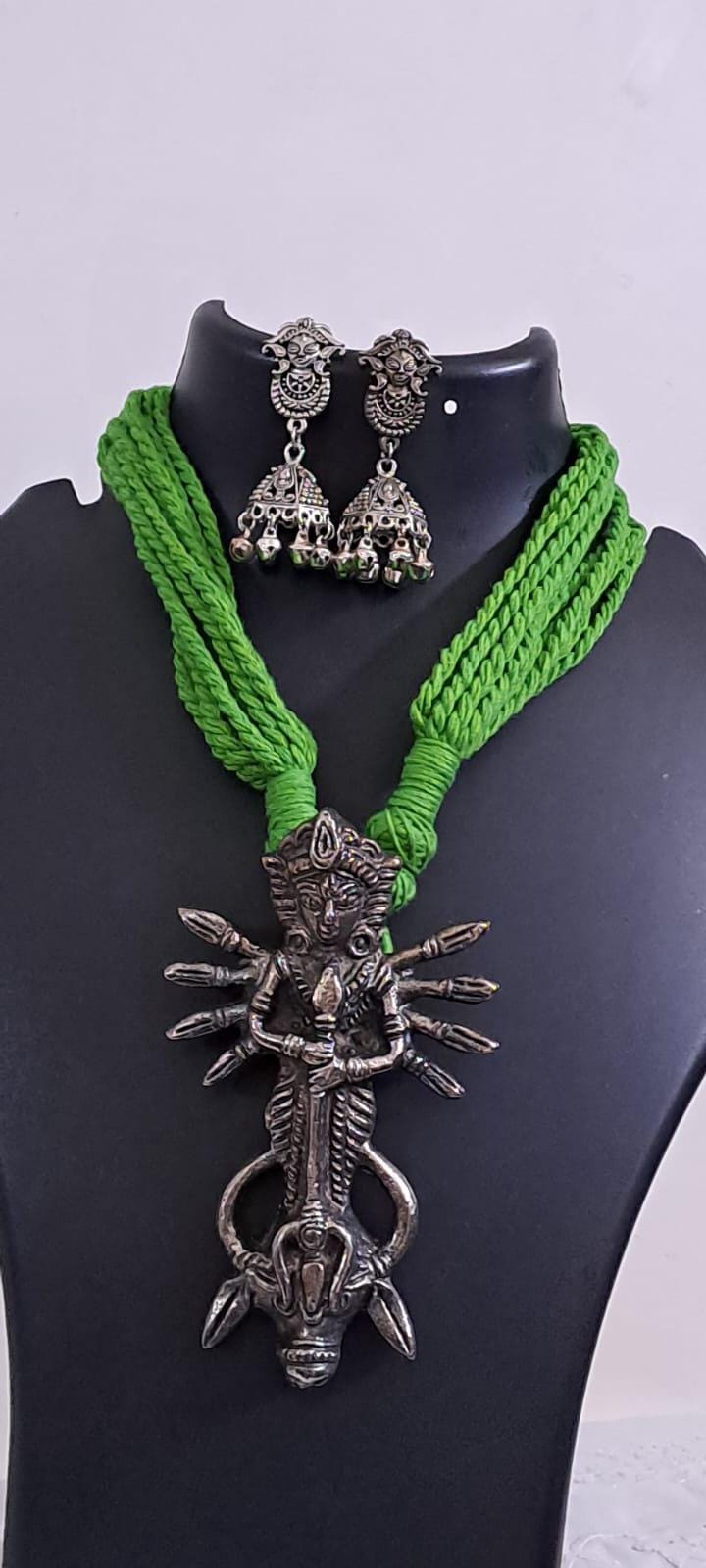 Green thread necklace with oxidised silver durga pendant