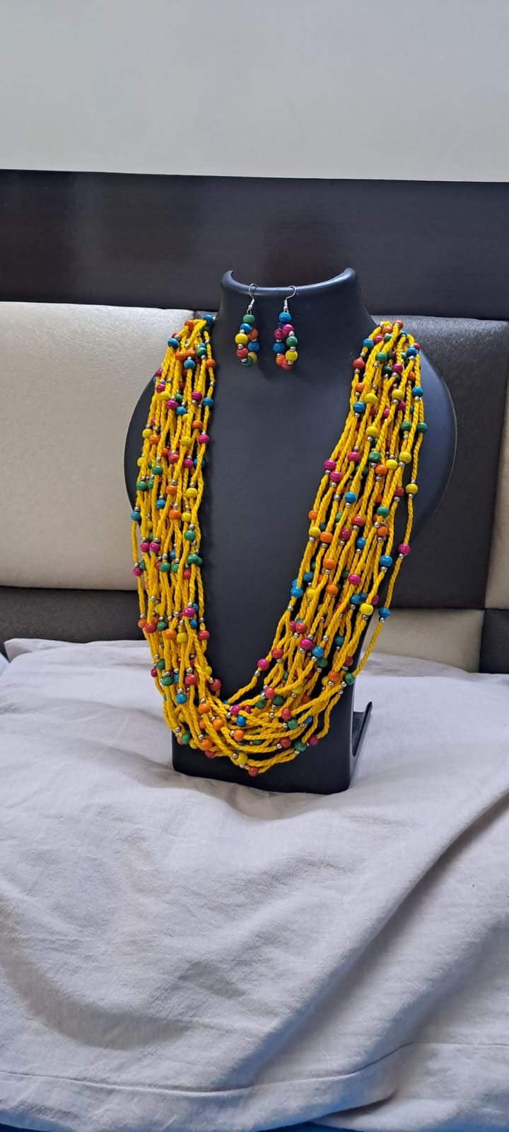 Yellow Multi layered necklace with colouful beads and with matching earrings.