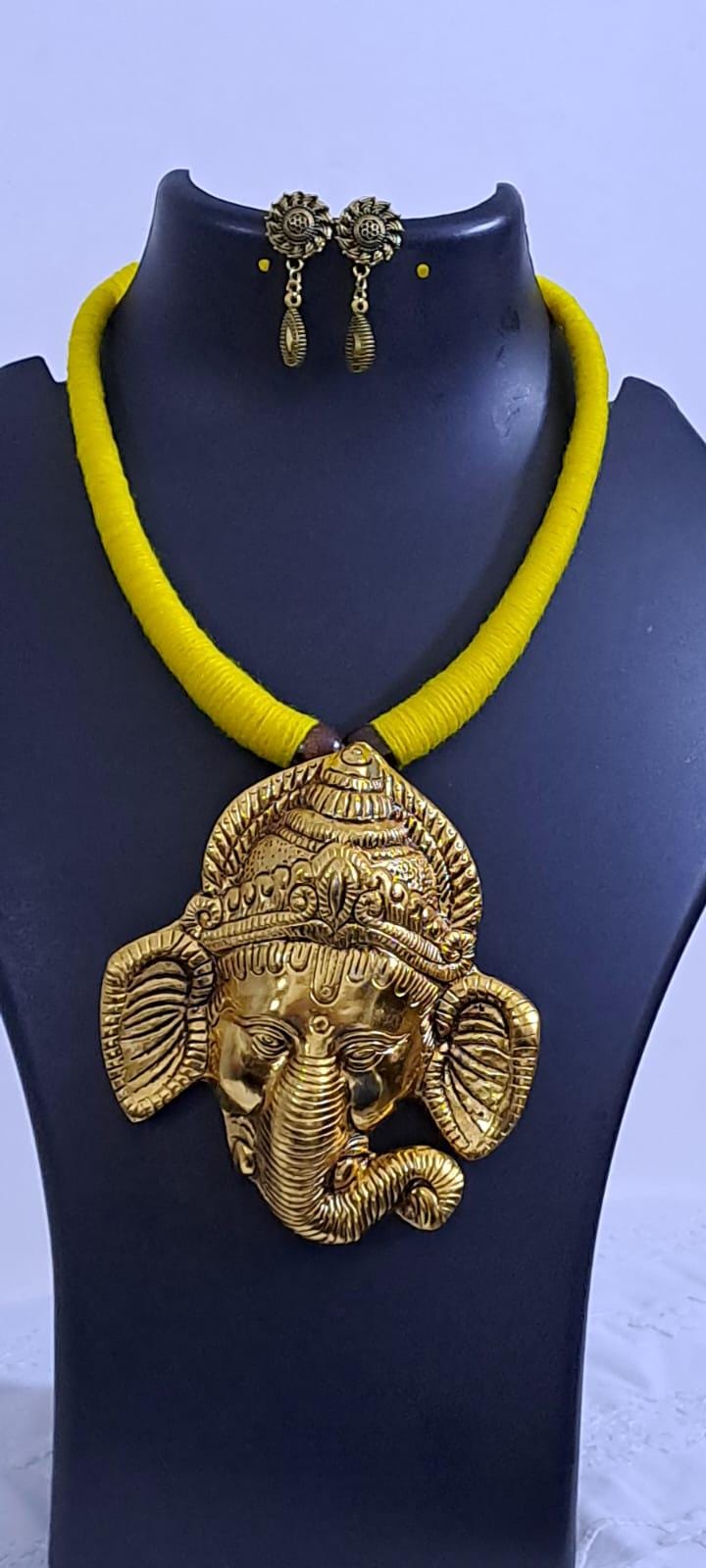 Yellow thread necklace with golden oxidised ganesha pendant