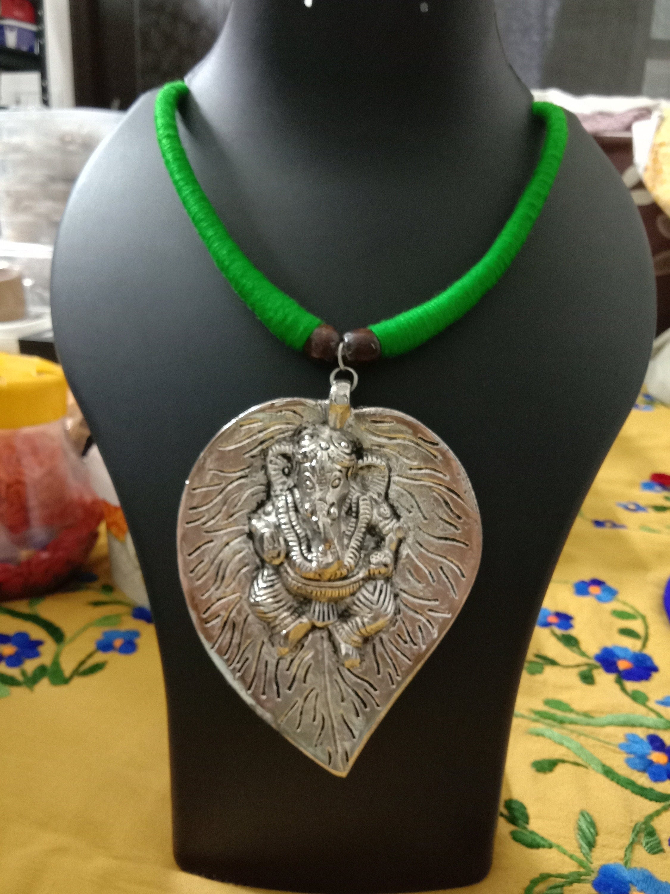 Green thread necklace with silver oxidised ganesha pendant