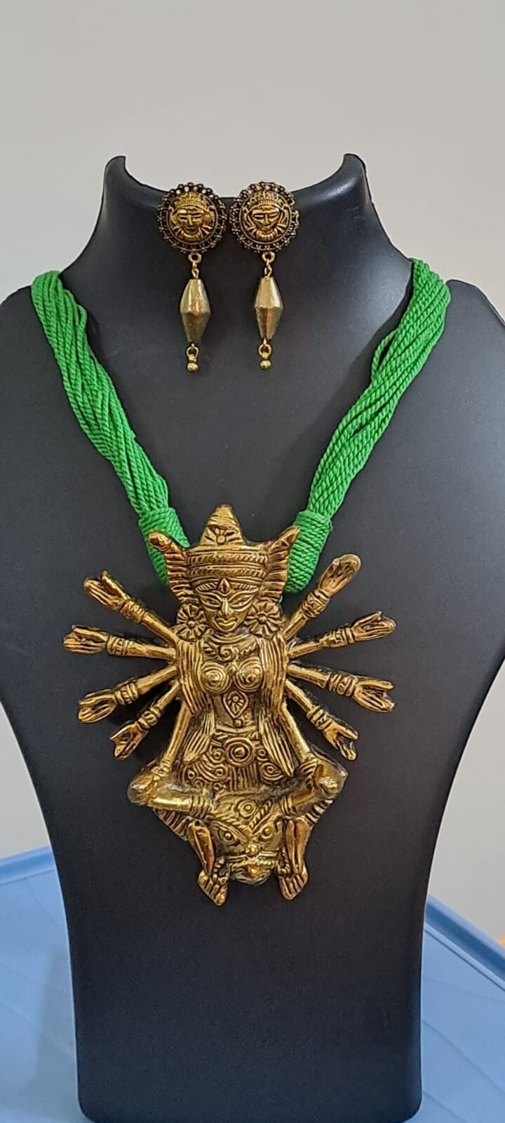 Green thread necklace with oxidised golden durga pendant