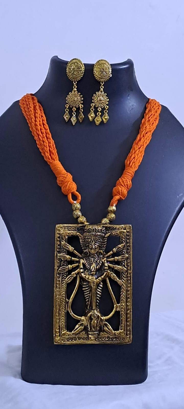 Orange thread necklace with oxidised golden durga pendant