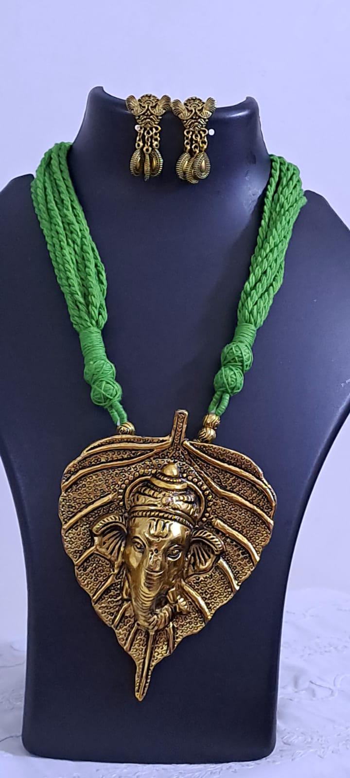 Green thread necklace with golden oxidised ganesha pendant