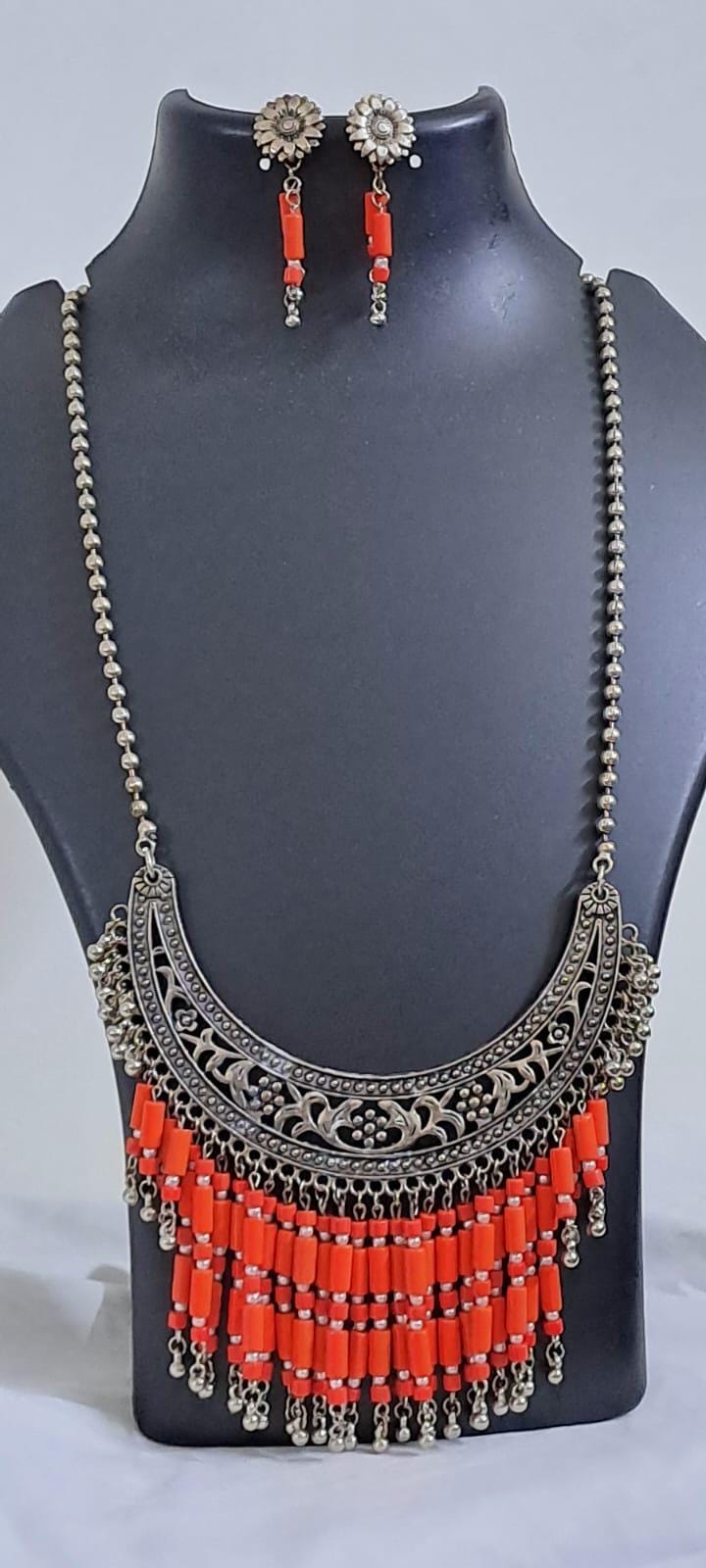Exclusive necklace with silver oxidised big oval pendant with glass beads fringes and matching earrings.