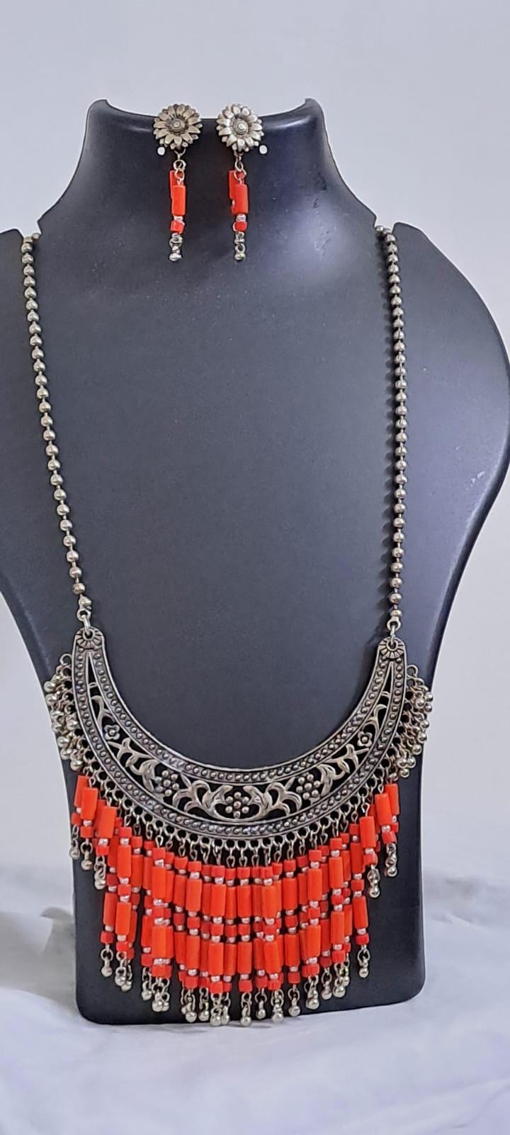Exclusive necklace with silver oxidised big oval pendant with glass beads fringes and matching earrings.