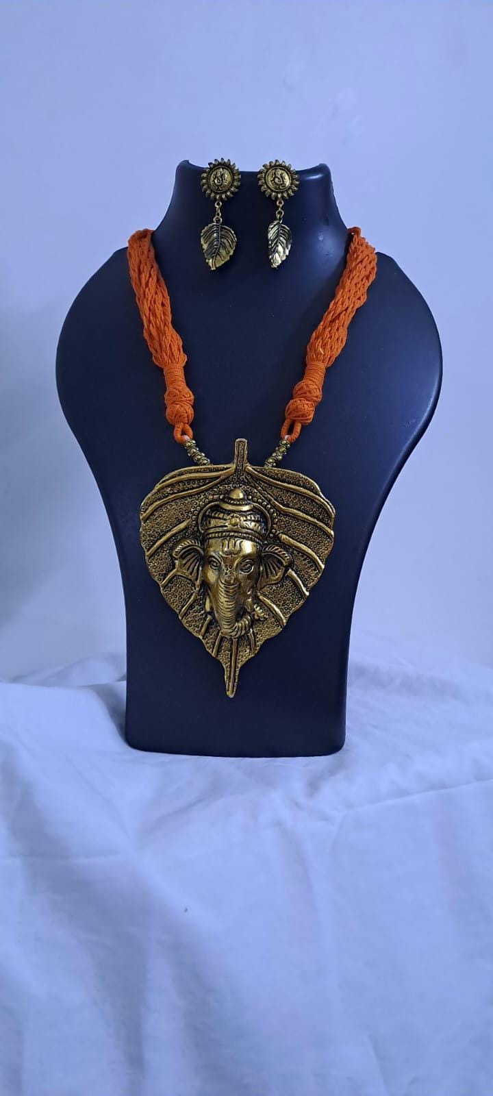 Orange thread necklace with golden oxidised ganesha pendant