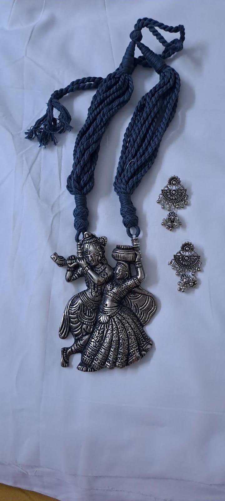 Radha Krishna silver oxidised pendant necklace in grey thread with matching earrings