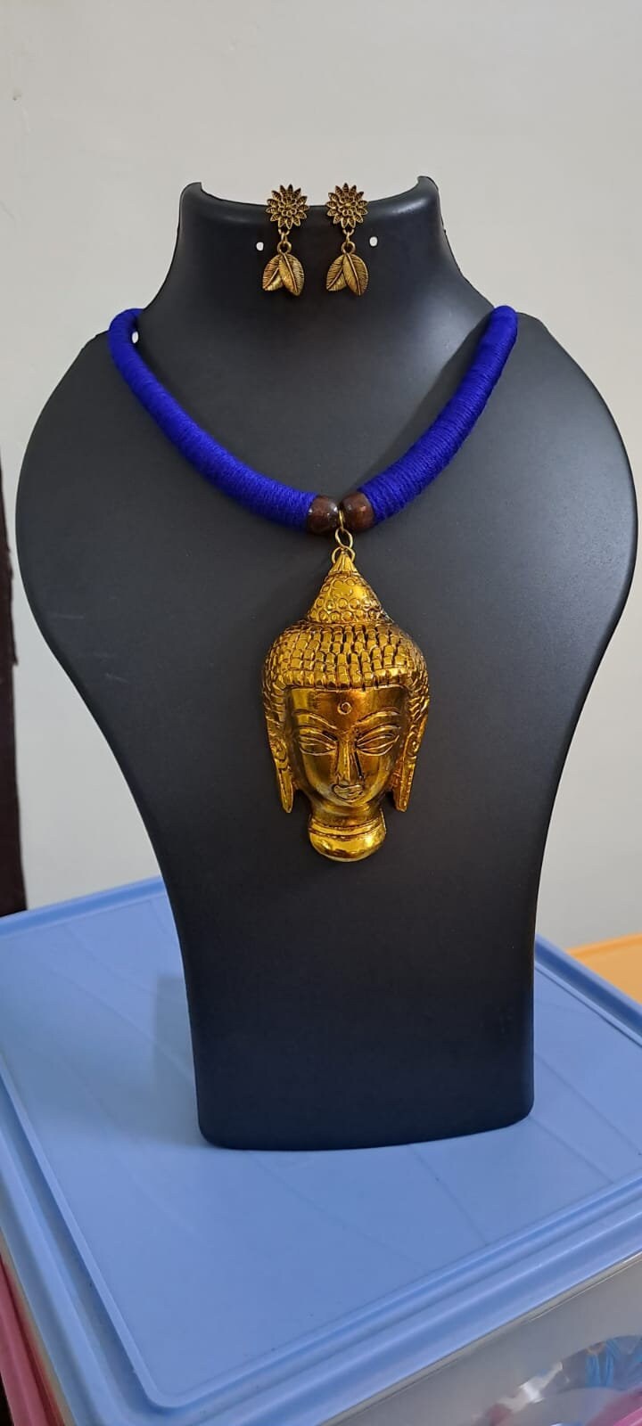 Blue thread necklace with golden oxidised buddha pendant