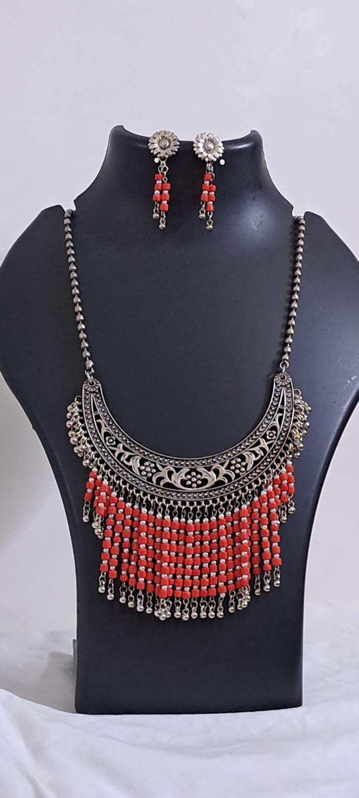Exclusive necklace with silver oxidised big oval pendant with glass beads fringes and matching earrings.