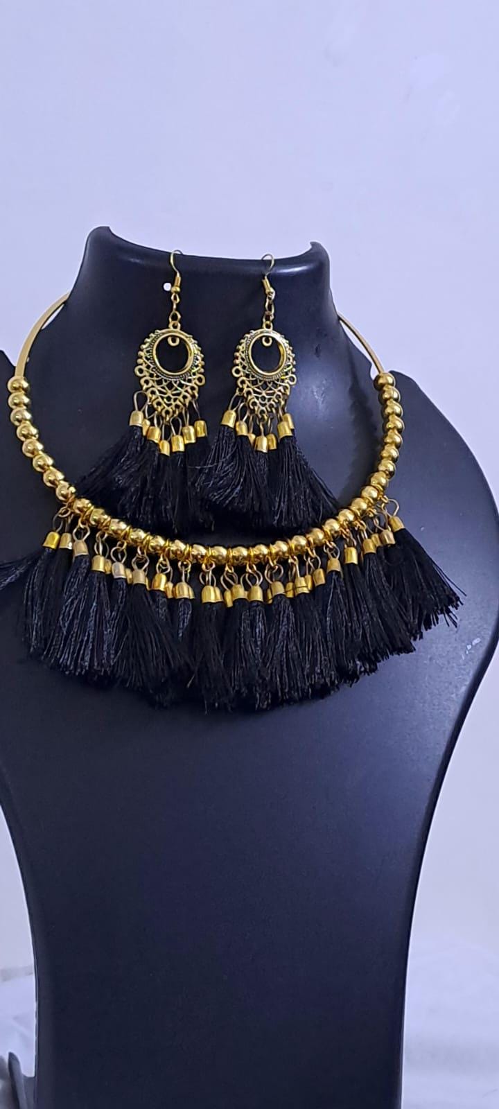 Golden neckband with black silk thread fringes and matching earrings