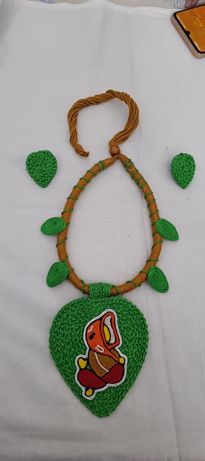 Exclusive light green and brown  thread necklace with leaf shaped  Ganesha pendant  and matching earrings.