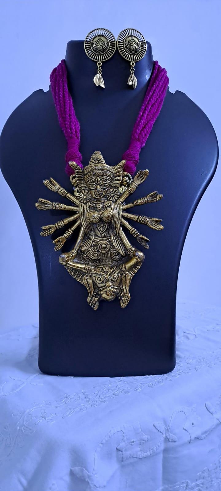 Pink thread necklace with oxidised golden durga pendant