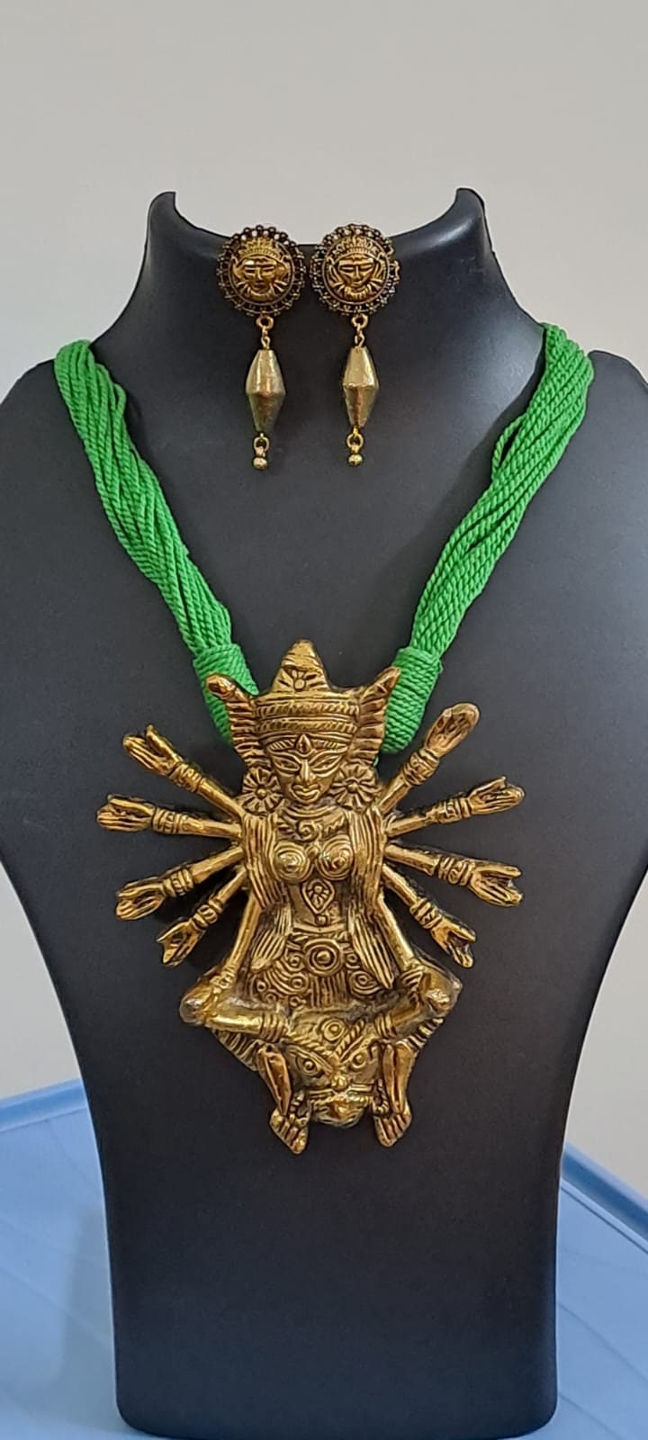 Green thread necklace with oxidised golden durga pendant