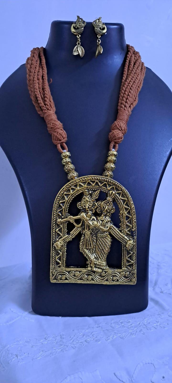 Radha Krishna golden oxidised pendant necklace in brown tread with matching earrings