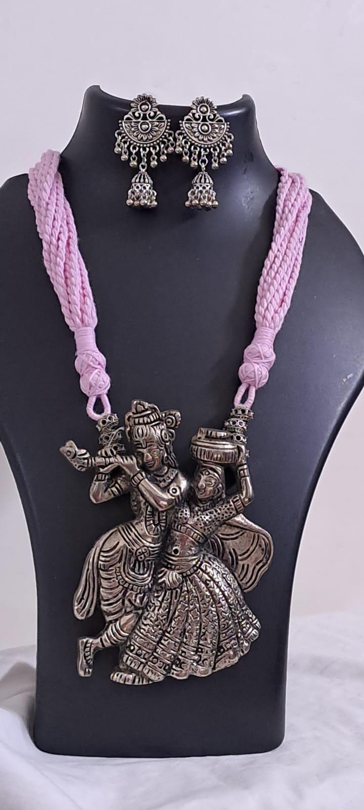 Radha Krishna silver oxidised pendant necklace in pink thread with matching earrings