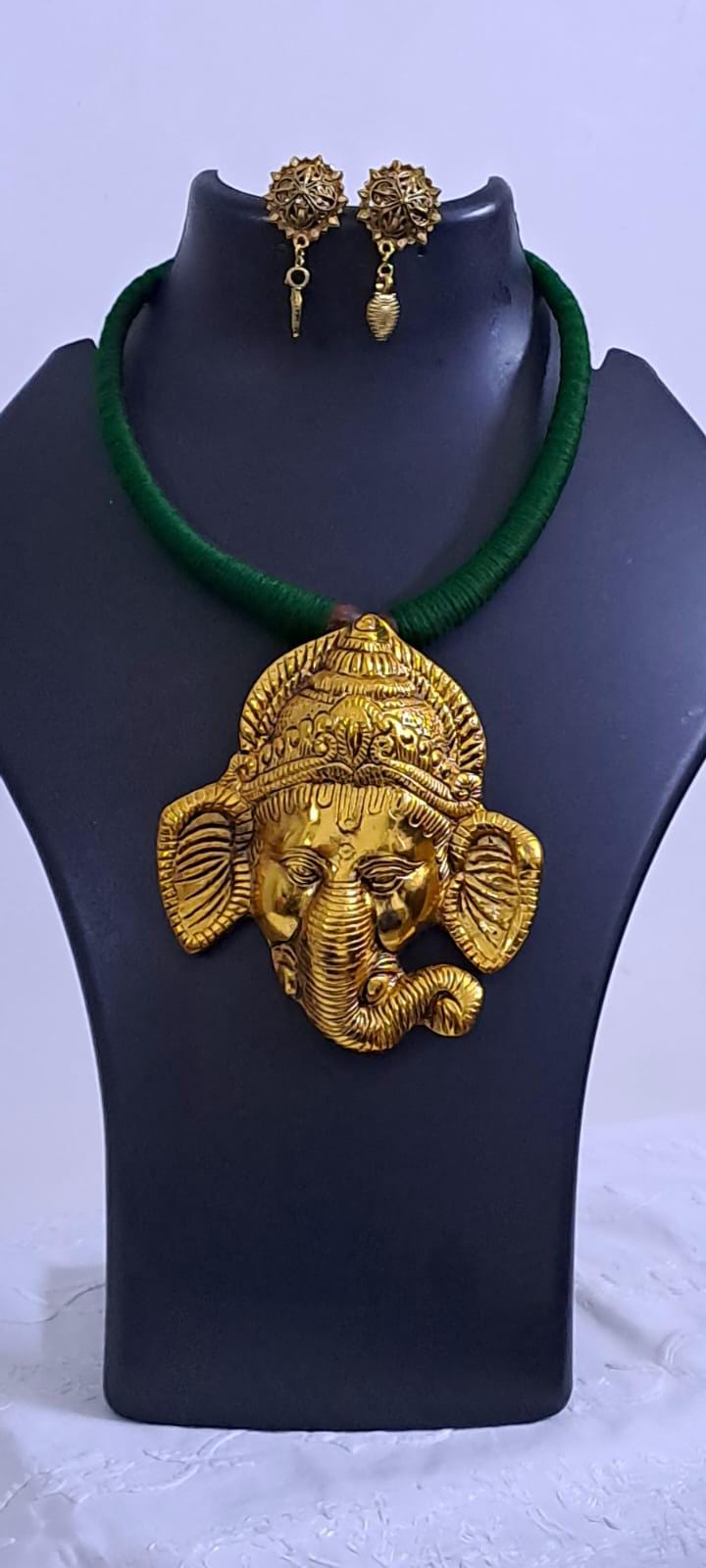 Green thread necklace with golden oxidised ganesha pendant