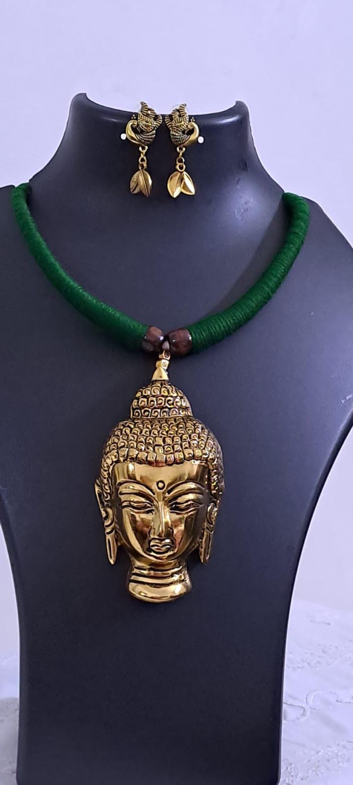 Green thread necklace with oxidised golden buddha pendant