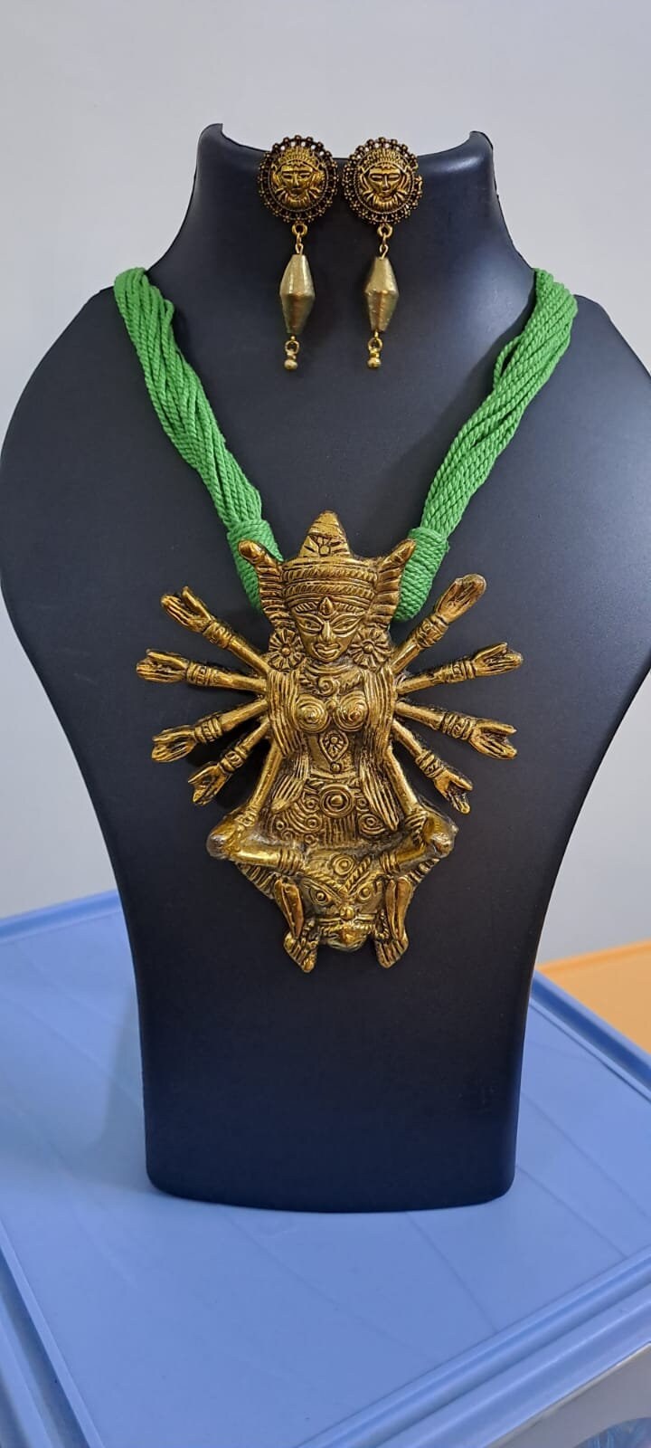 Green thread necklace with oxidised golden durga pendant