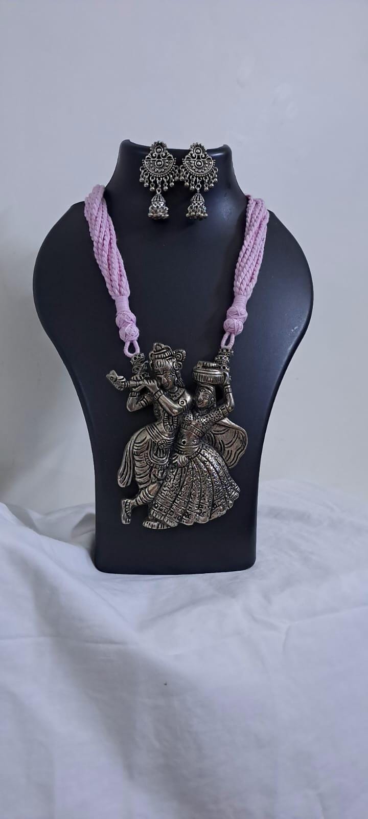 Radha Krishna silver oxidised pendant necklace in pink thread with matching earrings
