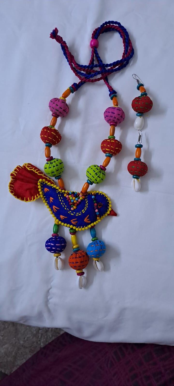 Exclusive fabric necklace with embroidered blue fabric bird pendant and fabric beads n matching beads
