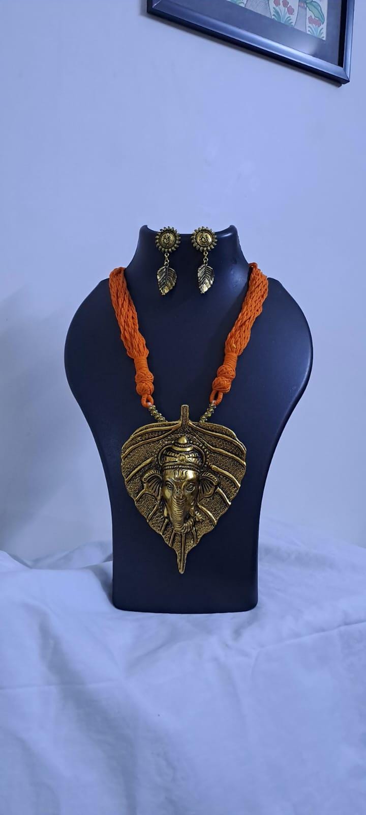 Orange thread necklace with golden oxidised ganesha pendant