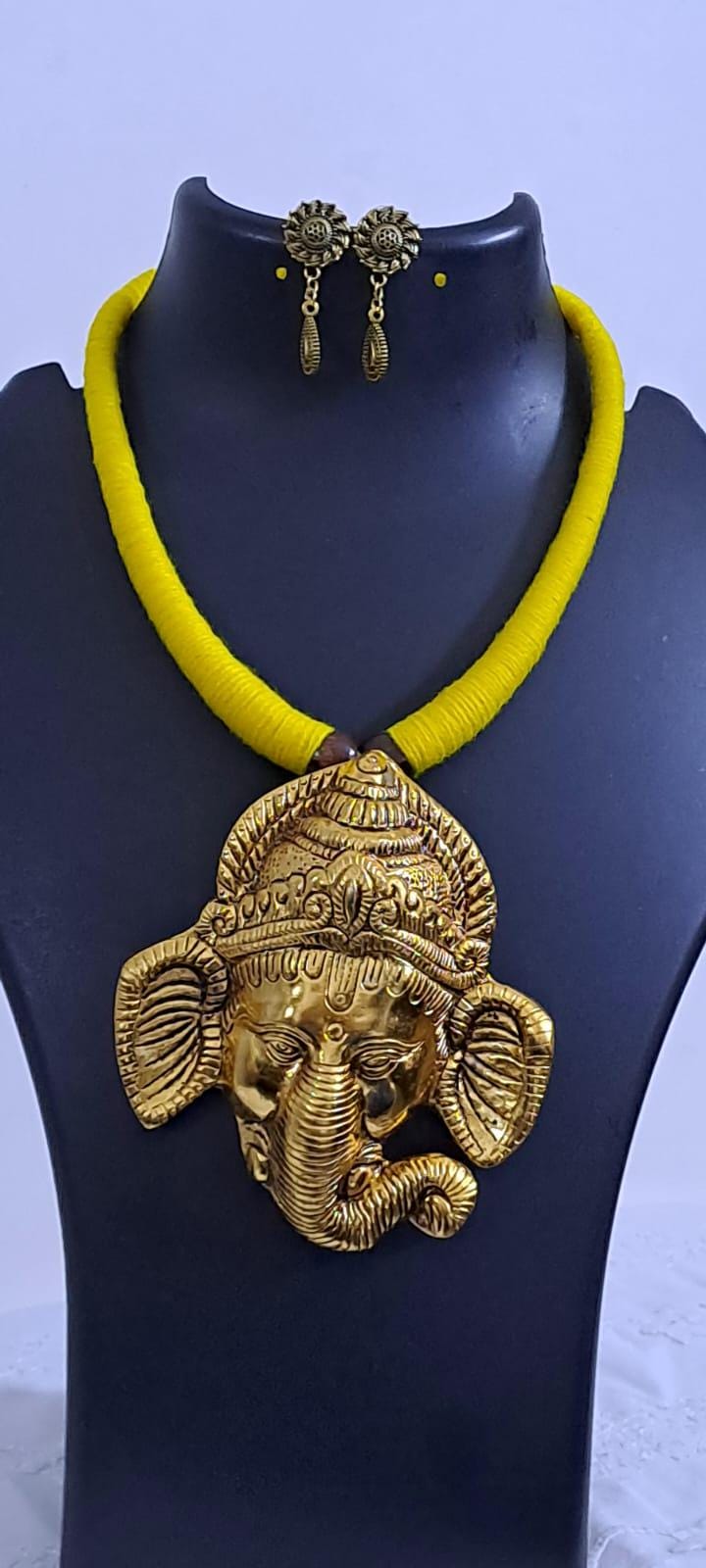 Yellow thread necklace with golden oxidised ganesha pendant