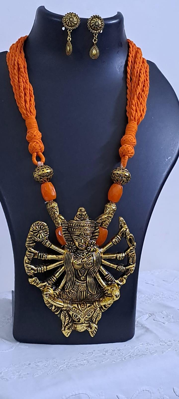 Orange thread necklace with oxidised golden durga pendant