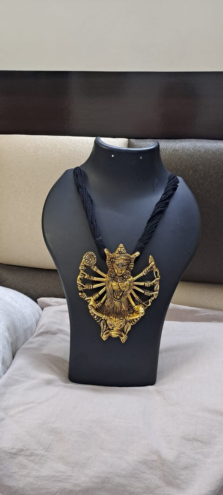 Black thread necklace with oxidised golden durga pendant