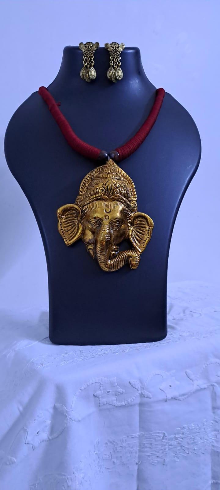 Maroon thread necklace with golden oxidised ganesha pendant