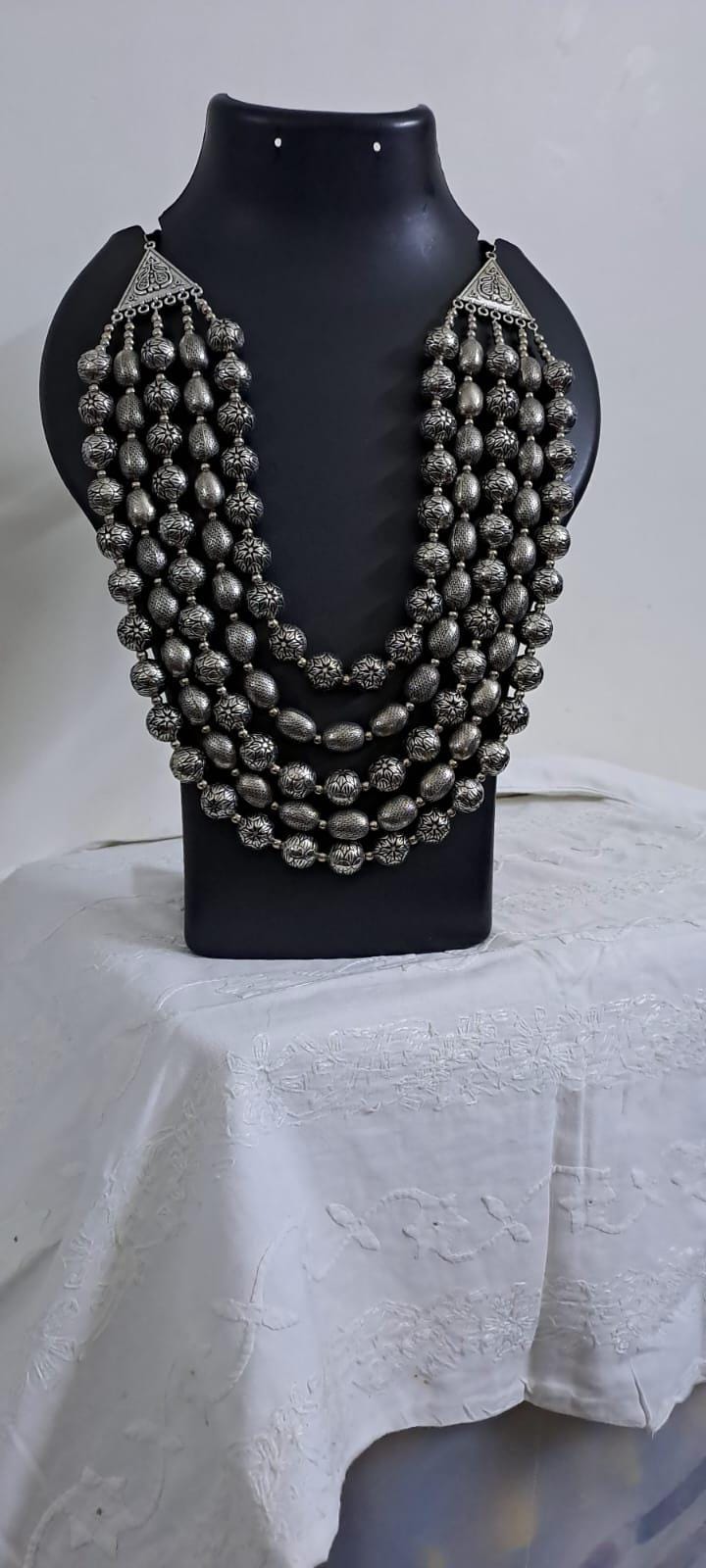 Multi-layered silver oxidised beads necklace .