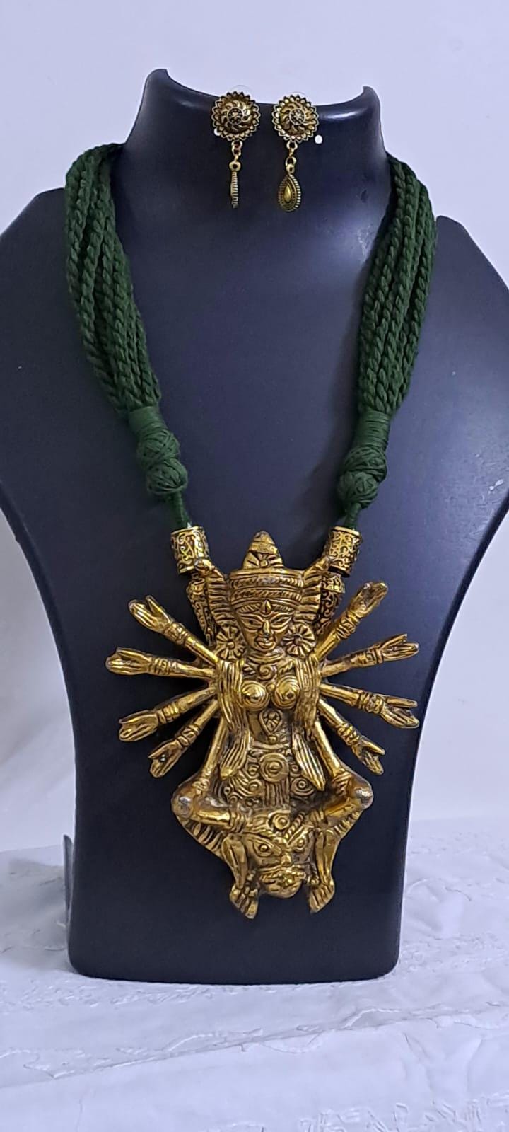 Green thread necklace with oxidised golden durga pendant