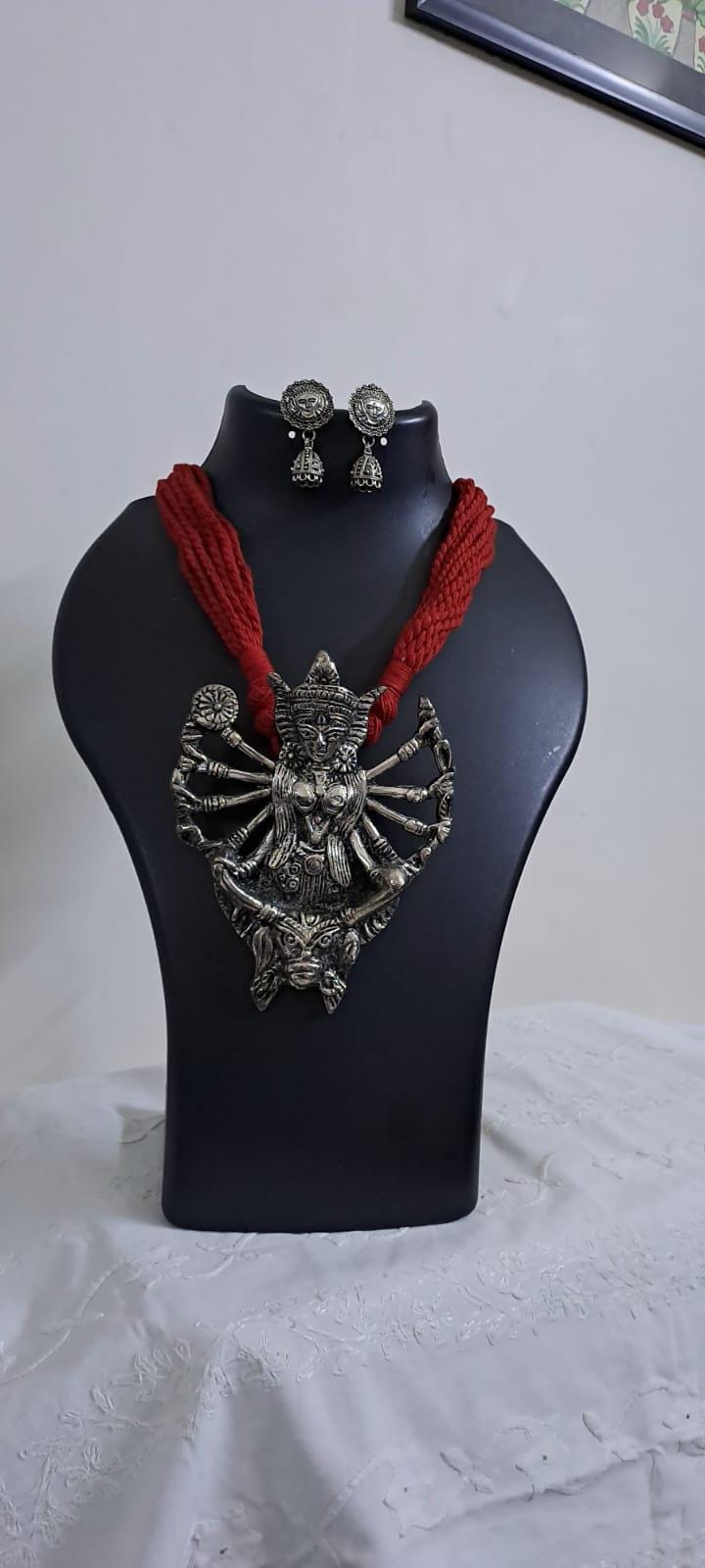 Red thread necklace with oxidised silver durga pendant