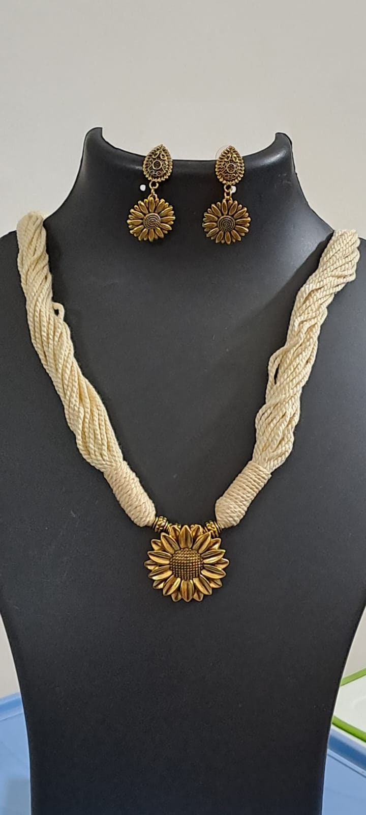 Off white thread necklace with oxidised silver sunflower pendant