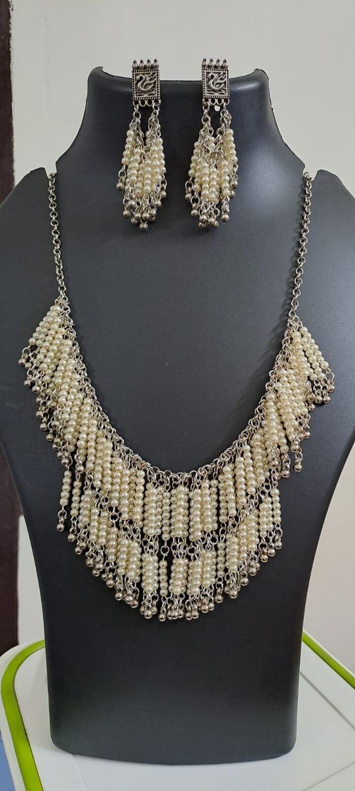 Exclusive layered off white seed beads necklace with matching hanging earrings.