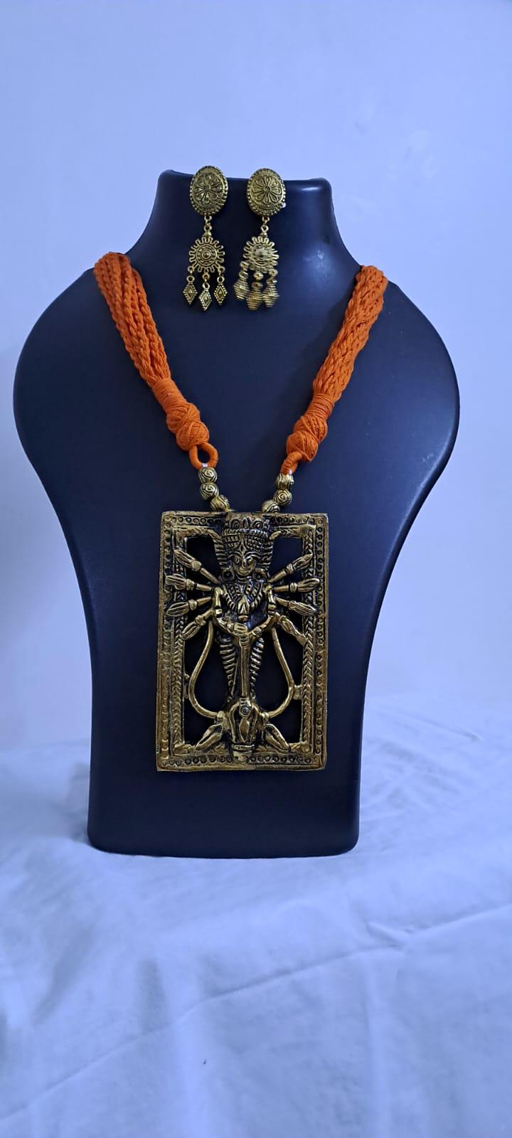 Orange thread necklace with oxidised golden durga pendant