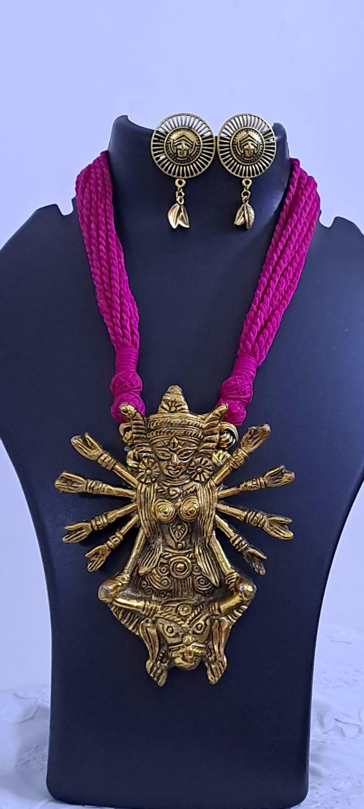 Pink thread necklace with oxidised golden durga pendant